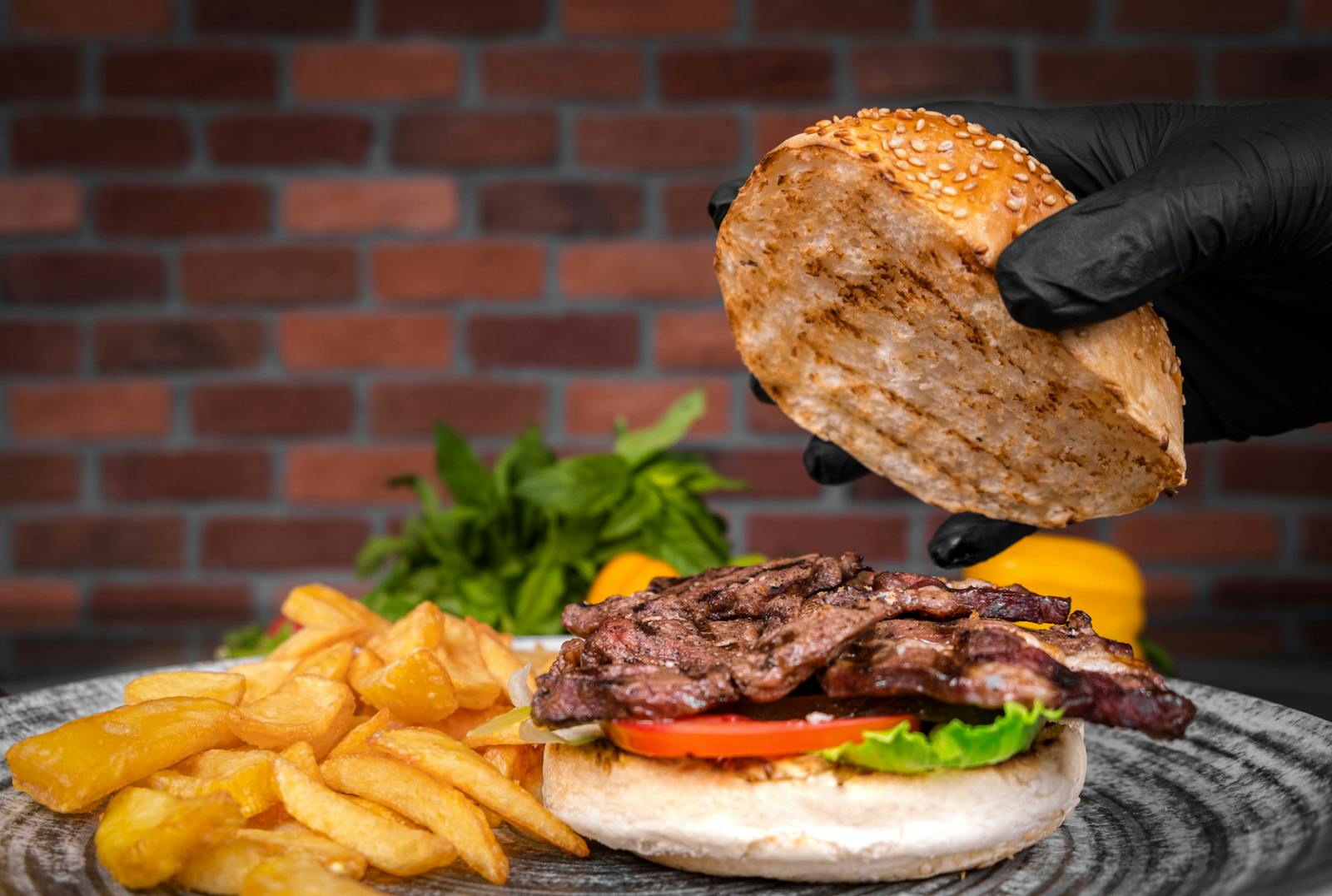 Mouth-watering grilled beef burger with fresh toppings and crispy fries, ready to serve.