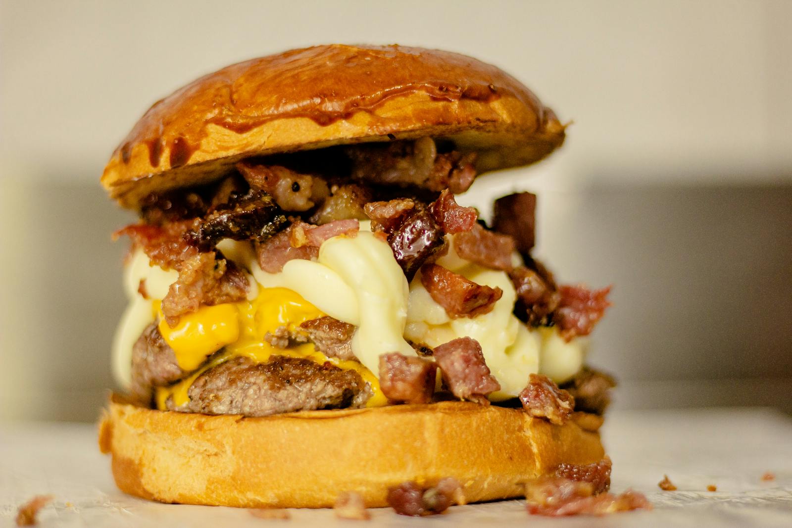 Close-up of a mouthwatering burger with melted cheese and crispy bacon.