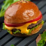 cheese burger on a wooden surface