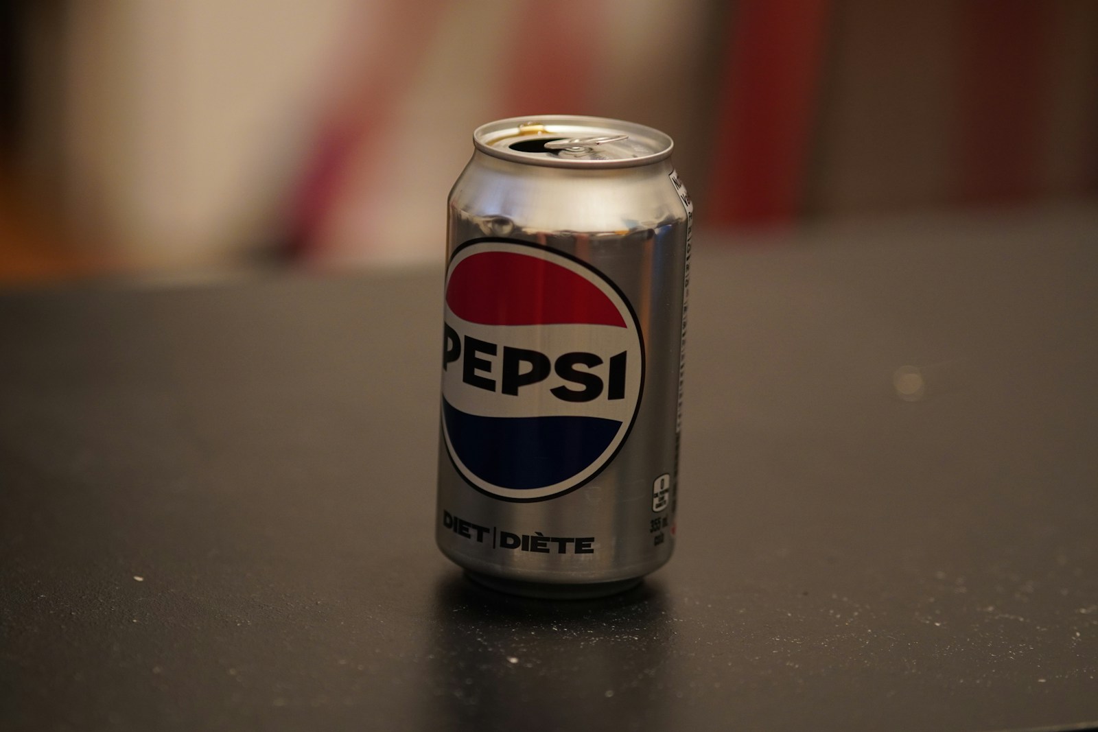 A can of pepsi sitting on top of a table