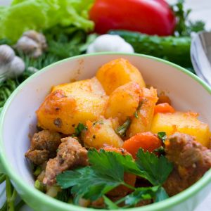 meat dish on green and white ceramic bowl