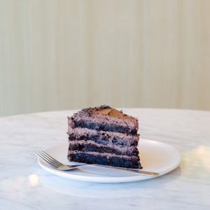 sliced chocolate cake beside fork on plate