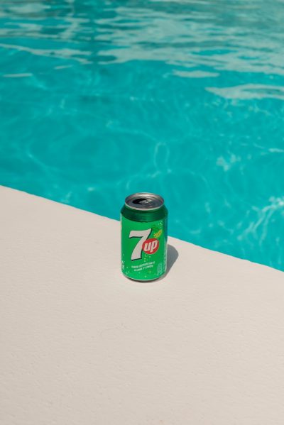 a can of 7up next to a swimming pool