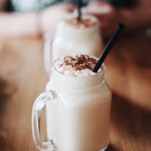 jar with handle filled with cream and chocolate on table