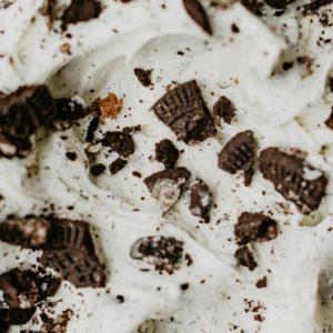 Close-up of creamy ice cream topped with chocolate cookie crumbles, a delightful dessert treat.