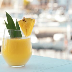 yellow juice in clear drinking glass